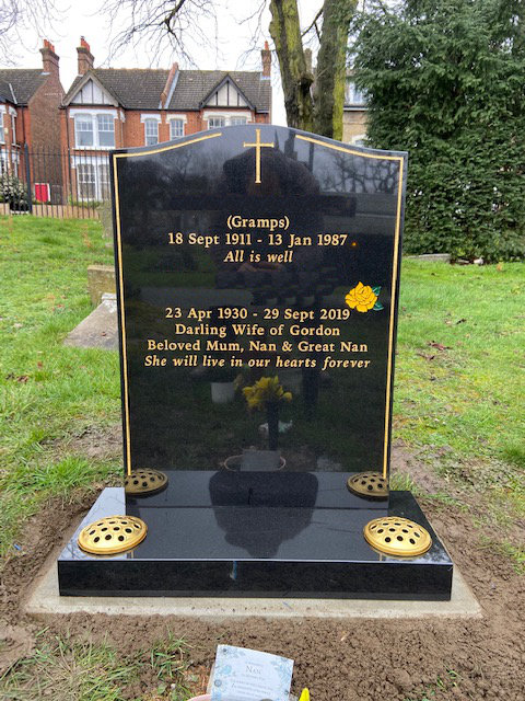 black granite memorial with gold keyline & cross