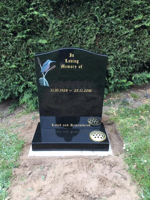 black granite headstone with kingfisher