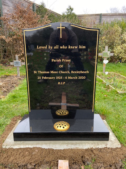 black granite headstone with gold pinline & cross