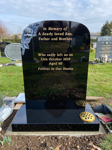 black granite memorial with antiqued carved rose